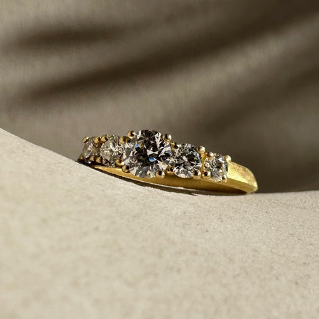 Edwardian style engagement ring featuring 5 brilliant round diamonds in four claw settings. By contemporary jewellery designer, Sarah Straussberg