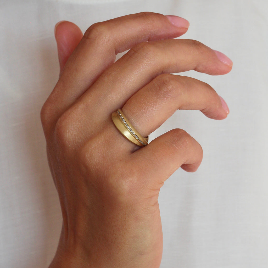 Bold eternity ring with champagne coloured diamonds photographed on a hand by contemporary jewellery designer, Sarah Straussberg