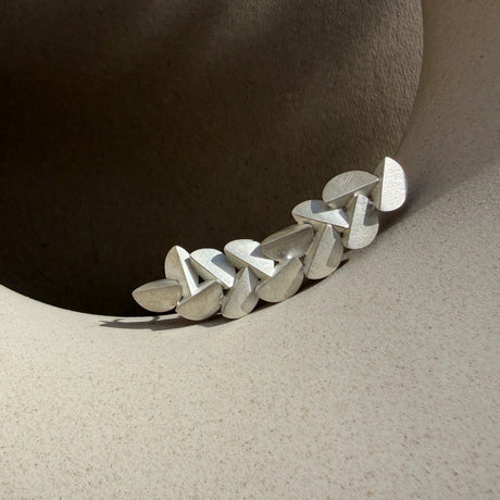 Modern silver brooch by contemporary jewellery designer, Sarah Straussberg