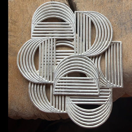 Graphic sterling silver brooch on the bench by contemporary jewellery designer, Sarah Straussberg
