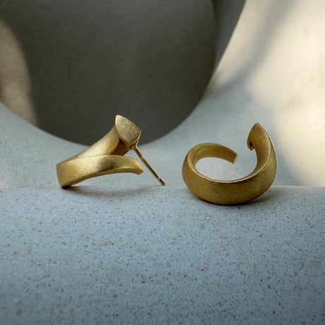 Signature gold loop earring design by contemporary jewellery designer, Sarah Straussberg