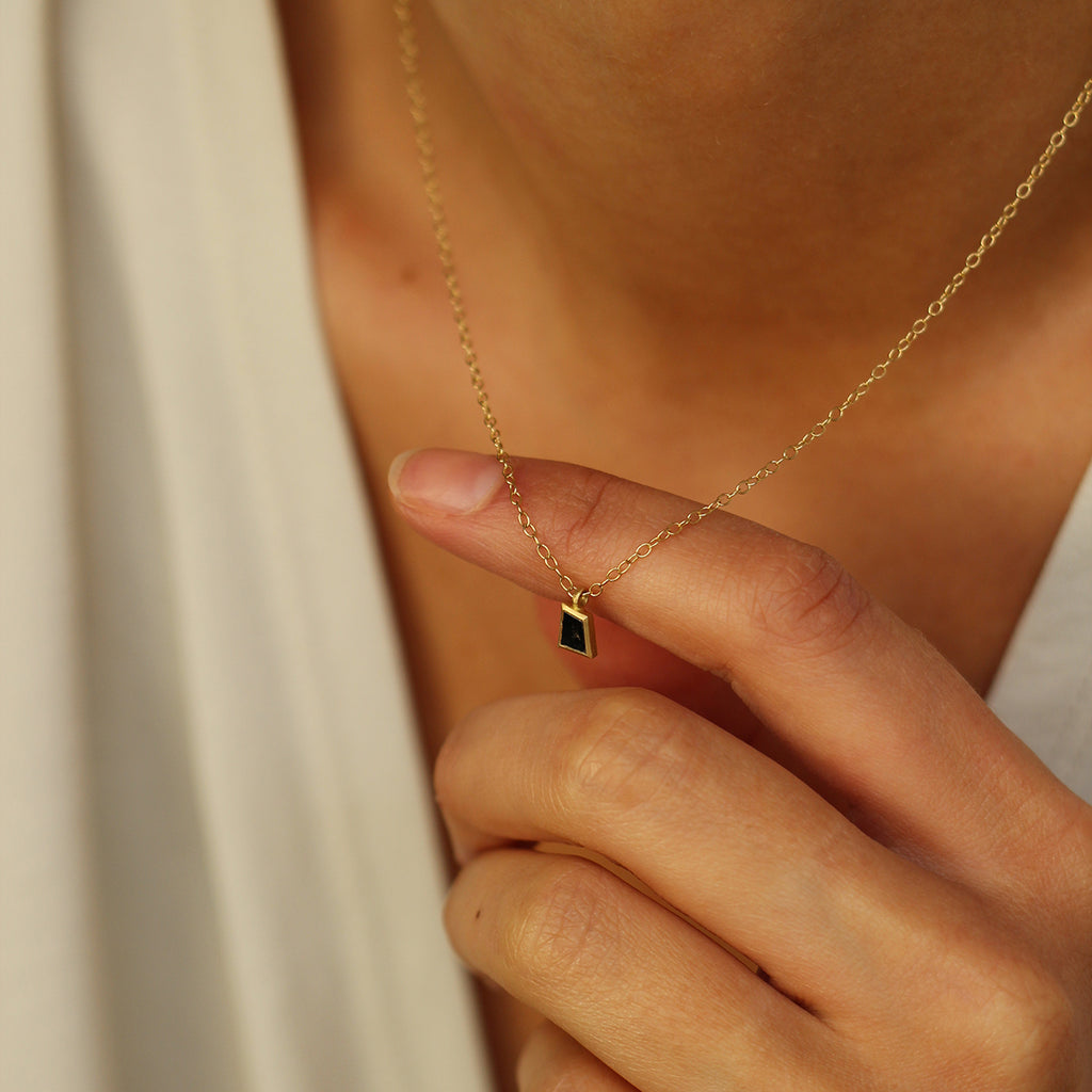 A salt and pepper diamond pendant on model by contemporary jewellery designer, Sarah Straussberg